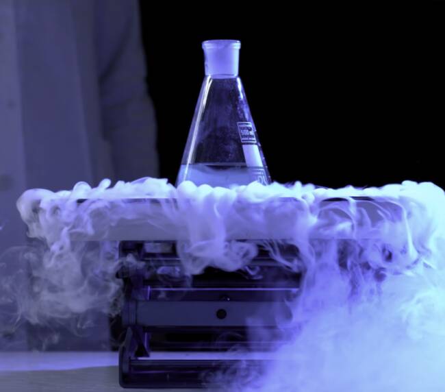 Bottle and liquid nitrogen in a laboratory. Chemical experiment. Flask with water and dry ice