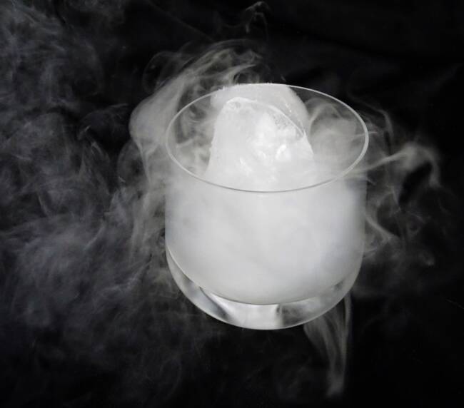 Experiment with Dry ice in a glass on a dark background